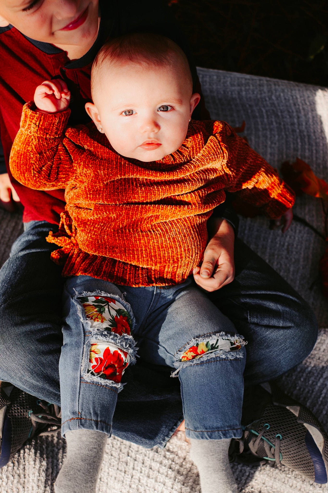 Evelyn is registered to the contest to win money with this photo: baby, cheek, child, comfort, eye, face, fun, happy, head, lap, leg, pattern, person, plaid, sitting, skin, smile, t_shirt, thigh, toddler