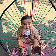 Jacob joined the competition — help win amazing prizes! baby, child, outdoor, chair, colorful, woven_chair, clothing, cute, expression, person, footwear, sunlight, garden, nature, sitting, portrait, casual_wear, happy, young_child, daylight