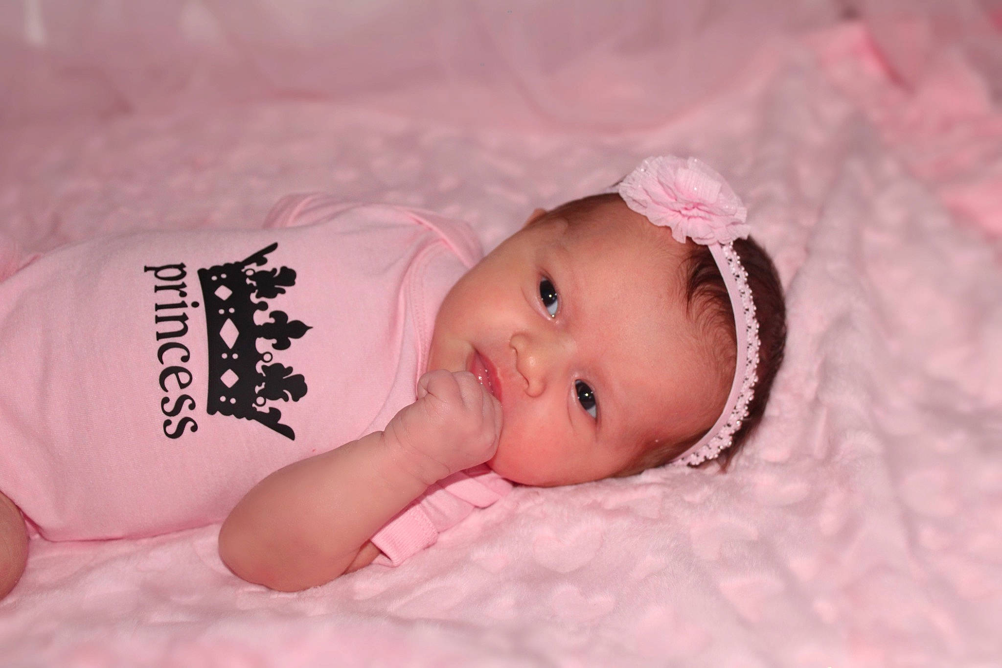 Mila is registered to the contest to win money with this photo: baby, baby_toddler_clothing, cheek, child, chin, comfort, eye, eyebrow, eyelash, flash_photography, happy, head, iris, linens, lip, magenta, person, pink, skin, sleeve