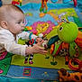 animal_print, baby, bright_colors, child, child_playing, colorful, crawling, curious, cute, development, early_learning, floor, indoor, infant, octopus, play_mat, plush_toy, soft_toy, toy, young_child