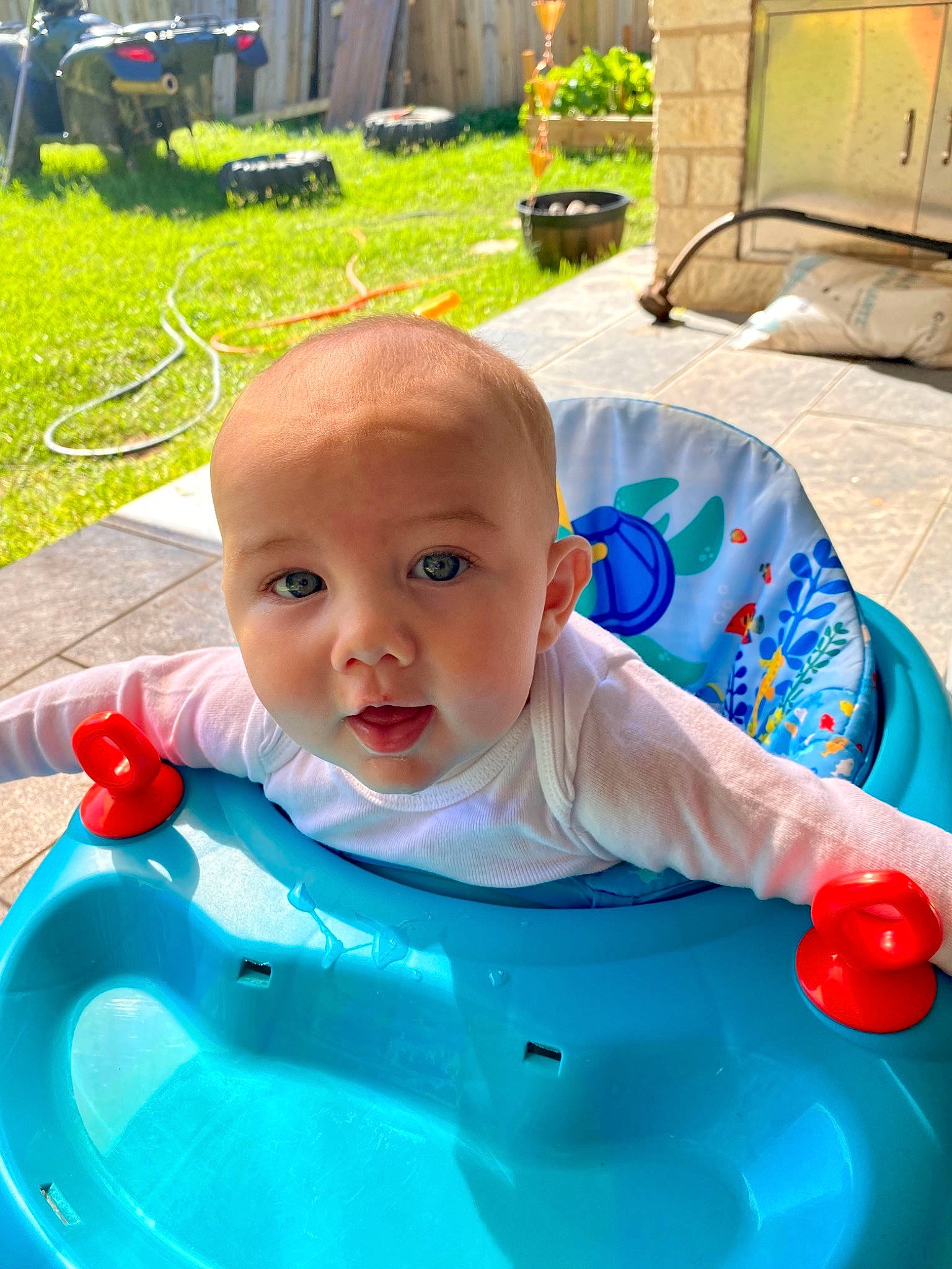 Corbin is registered to the contest to win money with this photo: baby, baby_products, baby_toddler_clothing, blue, chair, cheek, child, fun, grass, green, happy, leisure, person, photograph, plant, product, recreation, snapshot, toddler, water