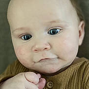 Bryce joined the competition — help win amazing prizes! baby, infant, child, hand, finger, skin, face, blue_eyes, clothing, button, portrait, cute, expression, holding, person, young, closeup, looking, indoor, warm
