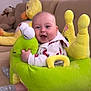 Eliya joined the competition — help win amazing prizes! baby, smiling, plush_toy, snail_seat, couch, stuffed_animal, indoor, child, happy, soft_toy, cozy, cute, infant, seated, clothing, home, playful, comfort, face, expression