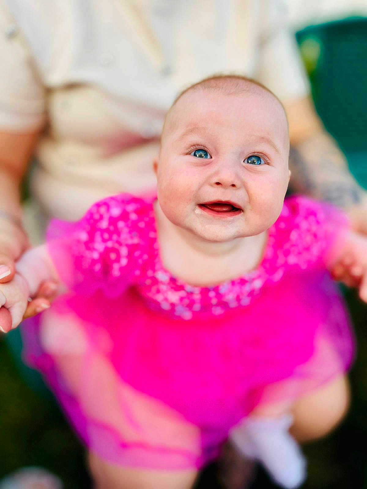 Eliya joined the competition — help win amazing prizes! baby, child, smiling, pink_dress, blue_eyes, happy, portrait, infant, cute, person, holding_hands, outdoor, blurred_background, rosy_cheeks, toddler, clothing, face, head, joyful, closeup