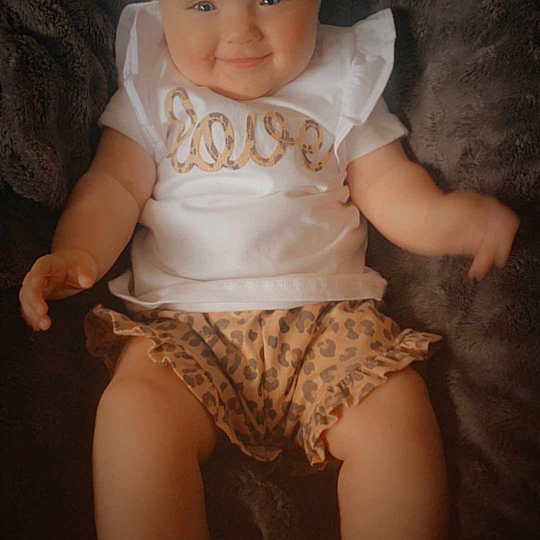 Kaci-Leigh joined the competition — help win amazing prizes! baby, bodypart, bonnet, clothing, couch, doll, dress, face, finger, furniture, hat, head, newborn, pants, person, photography, portrait, shorts, sitting, toy