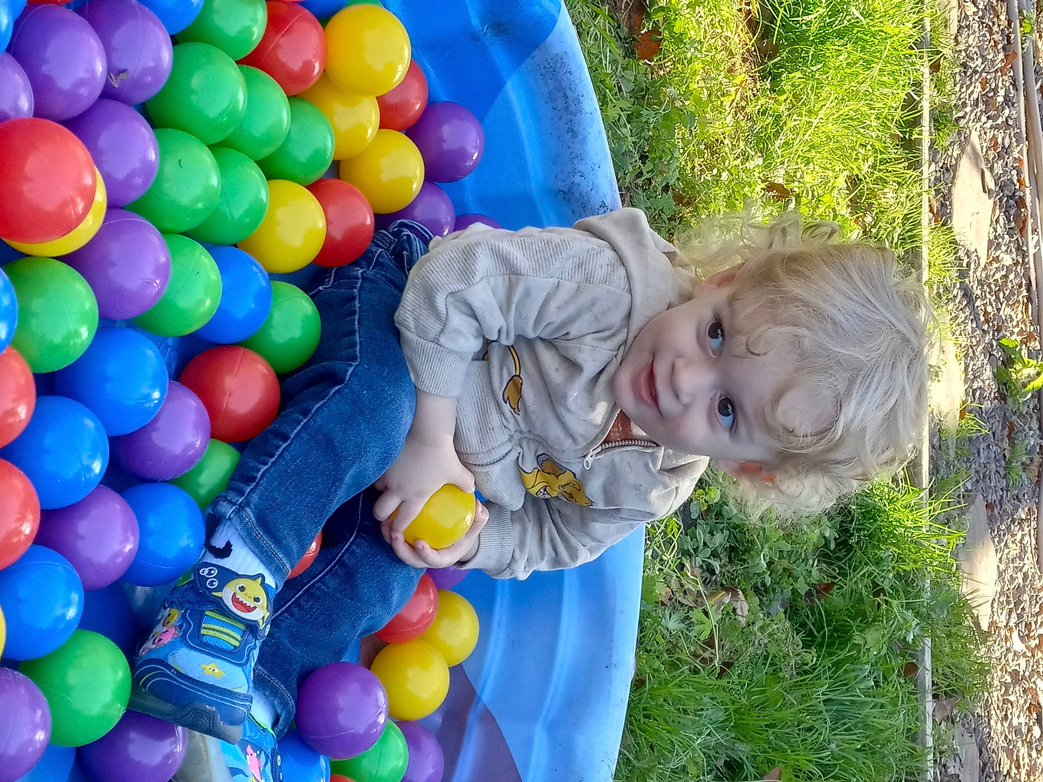 Kolten is registered to the contest to win money with this photo: baby, baby_laughing, baby_toddler_clothing, ball_pit, balloon, blue, child, electric_blue, event, fun, grass, happy, leisure, party_supply, people_in_nature, person, photograph, smile, toddler, tree