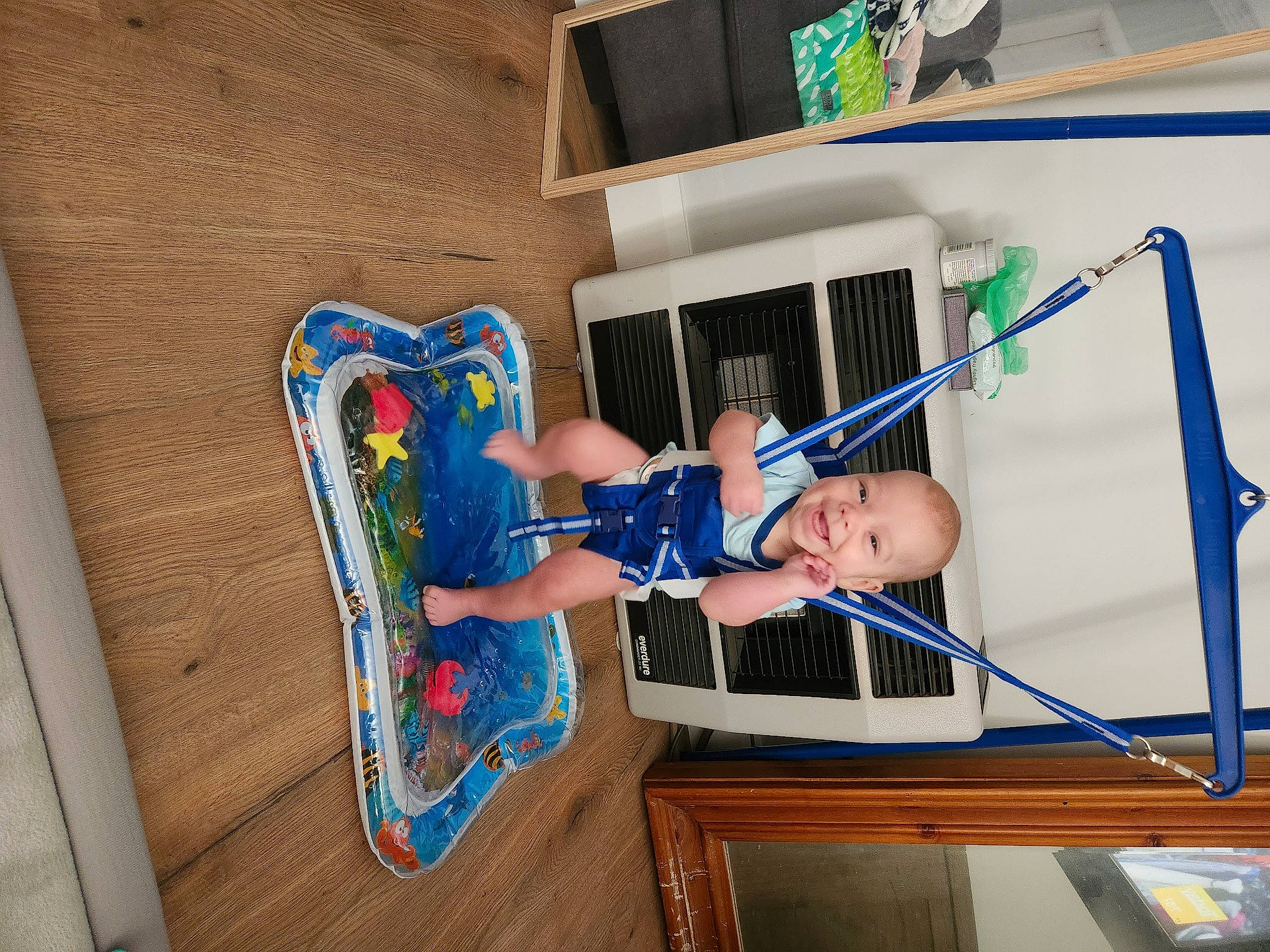Fletcher is registered to the contest to win money with this photo: baby, baby_toddler_clothing, child, elbow, electric_blue, flooring, fun, hardwood, hat, human_body, human_leg, joy, knee, leisure, person, play, room, t_shirt, thigh, toddler
