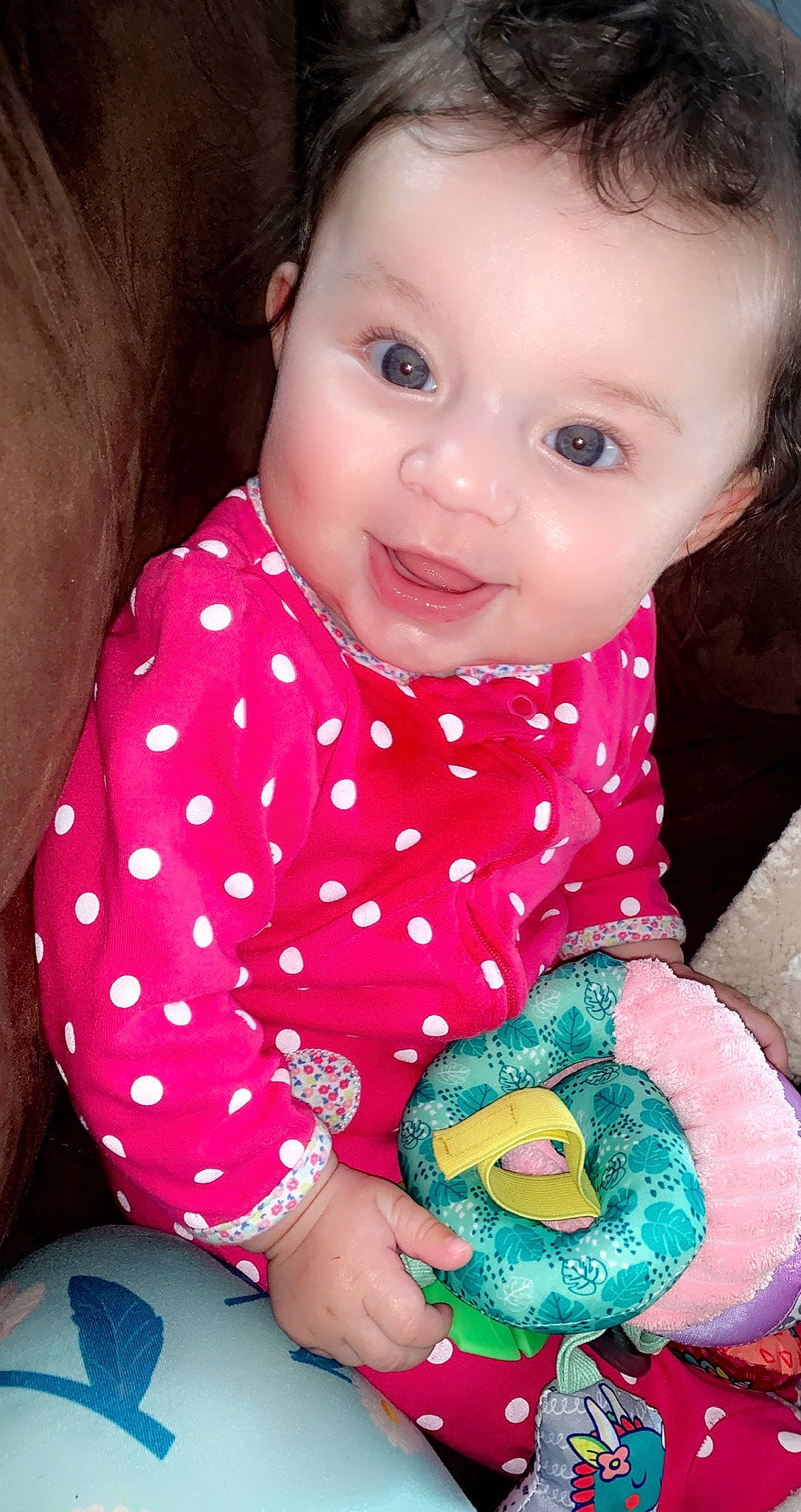 Sayge is registered to the contest to win money with this photo: arm, baby_toddler_clothing, cheek, clothing, eye, face, facial_expression, hand, happy, head, human, human_body, lip, mouth, nose, organ, person, skin, sleeve, smile