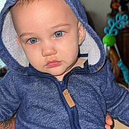 Liam joined the competition — help win amazing prizes! toddler, child, blue_eyes, hoodie, indoor, portrait, face, person, clothing, zipper, seated, hand, tattoo, furniture, background, window, light, expression, baby, cute