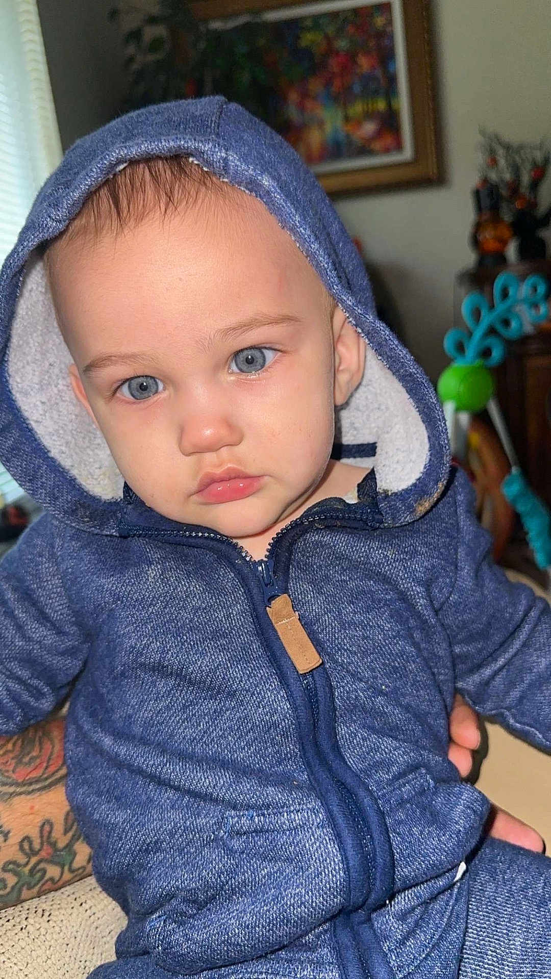 Liam joined the competition — help win amazing prizes! toddler, child, blue_eyes, hoodie, indoor, portrait, face, person, clothing, zipper, seated, hand, tattoo, furniture, background, window, light, expression, baby, cute