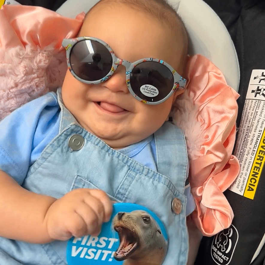 Elijah joined the competition — help win amazing prizes! baby, sunglasses, denim_overalls, car_seat, pink_satin, smile, tongue_out, infant, face, clothing, child, cute, playful, seatbelt, seat, person, blue, accessory, sticker, cheeky