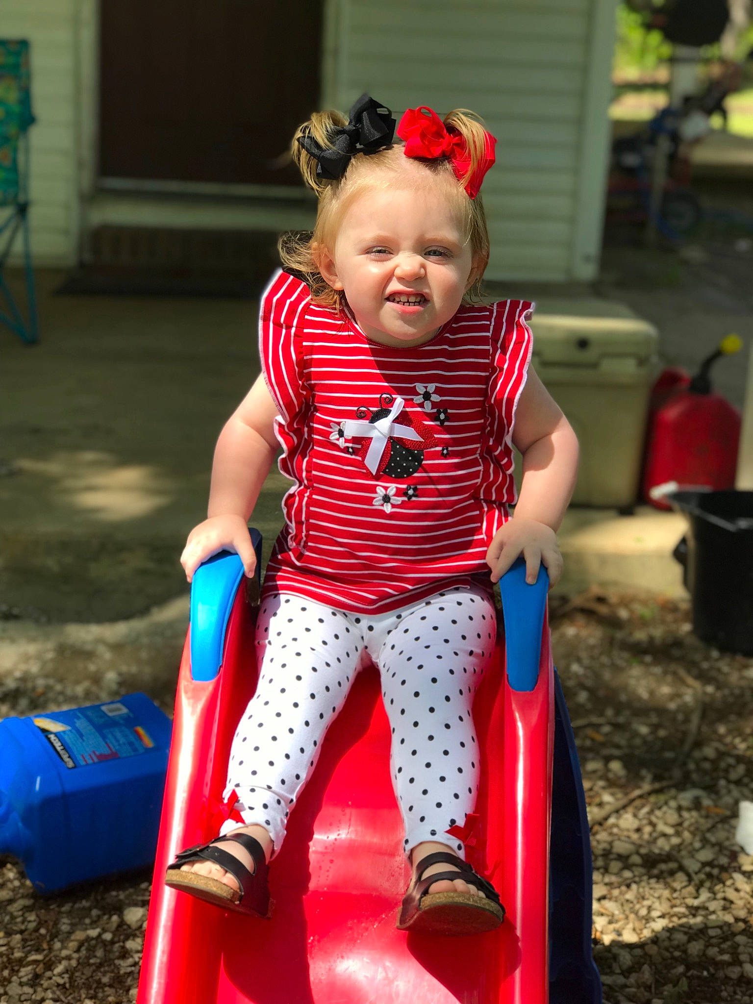 Raelynn joined the competition — help win amazing prizes! baby_products, child, fun, leisure, outdoor_play_equipment, person, play, playground, playground_slide, public_space, recreation, red, sitting, smile, toddler