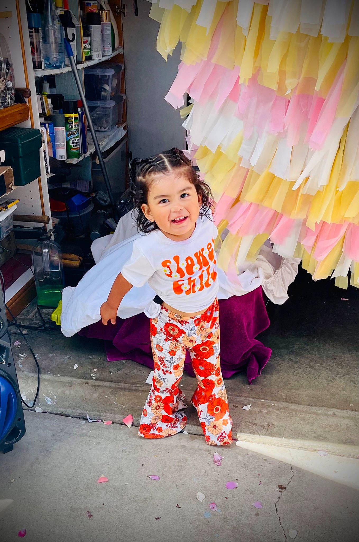 Zia is registered to the contest to win money with this photo: art, child, costume, face, fashion_accessory, fun, happy, joy, leisure, magenta, person, pink, play, public_space, shelf, shelving, sitting, smile, standing, street