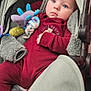baby, baby_girl_or_boy, blue_eyes, casual, child, comfort, contemplative, cozy, curious, cute, headwear, indoor, infant, maroon_clothing, plush_toy, portrait, seated, soft_padding, stroller, young_child