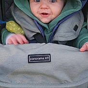 Kody joined the competition — help win amazing prizes! baby, baby_carrier, blue_hood, child, closeup, clothing, cozy, curious, cute, face, green_hood, hands, happy, hood, infant, jacket, outdoor, person, portrait, stroller