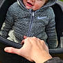 Kody is registered to the contest to win money with this photo: baby, blue_eyes, casual, child, closeup, cute, fuzzy_texture, gray_clothing, hand, happy, hoodie, outdoor, park, person, playground, seat, smile, swing, toy, winter_clothing