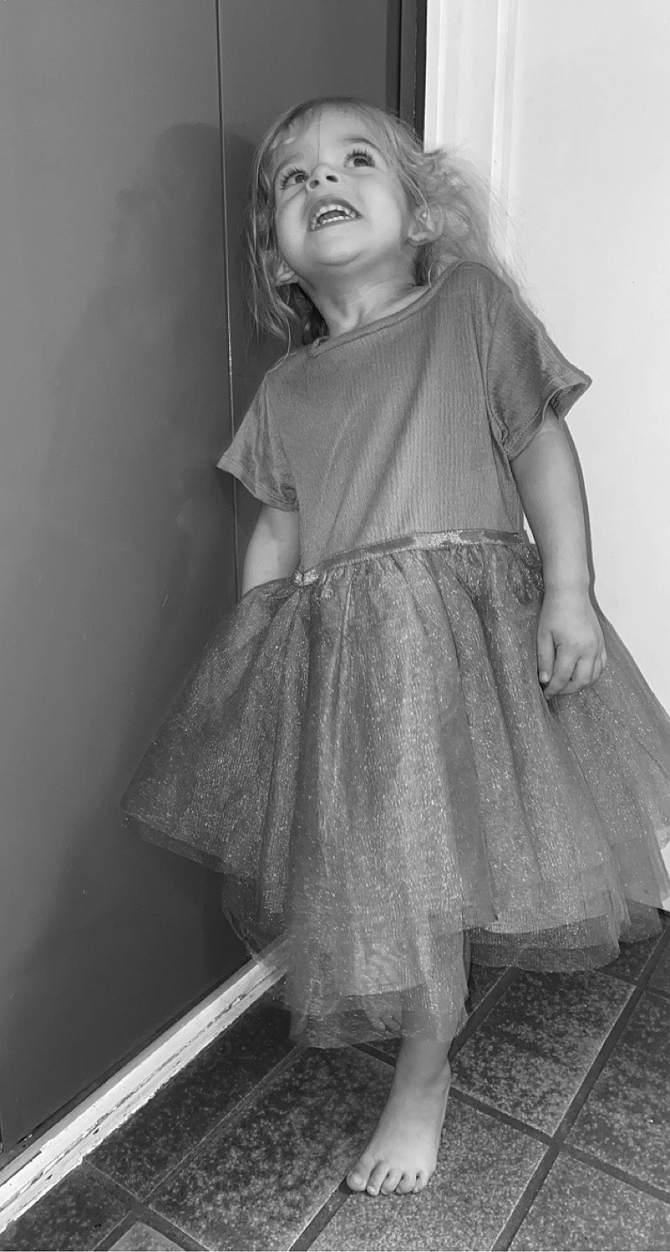 Cloé a rejoint le concours — aidez-le/la à gagner de superbes lots ! day_dress, dress, eye, face, flash_photography, hair, happy, head, human_body, iris, monochrome, monochrome_photography, one_piece_garment, person, shoulder, skin, smile, standing, style, toddler