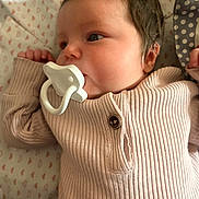 Rylee is registered to the contest to win money with this photo: baby, infant, pacifier, pink_clothing, ribbed_fabric, lying_down, blanket, heart_pattern, closeup, soft_lighting, child, cute, portrait, sleepwear, newborn, face, hand, indoors, peaceful, baby_girl