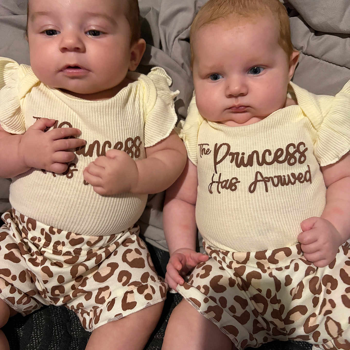Emily And Erica joined the competition — help win amazing prizes! baby, infant, twin, clothing, pattern, leopard_print, yellow_top, sitting, blanket, cute, portrait, indoors, child, face, skin, hand, expression, person, fashion, newborn