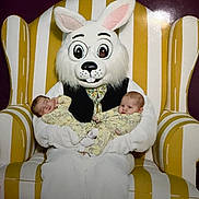 Emily And Erica joined the competition — help win amazing prizes! baby, bunny_costume, child, cute, easter, face, infant, mask, person, plush, pajamas, portrait, seat, striped_chair, toy, yellow, white, costume, smile, indoor