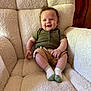 Bodie joined the competition — help win amazing prizes! baby, child, smiling, armchair, green_shirt, khaki_shorts, socks, indoor, wood_wall, comfortable, happy, seated, cozy, cute, portrait, infant, furniture, casual_clothing, skin, person