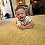Bodie joined the competition — help win amazing prizes! baby, infant, carpet, smile, drool, curly_hair, indoor, person, floor, onesie, furniture, shelf, blurred_background, living_room, cute, child, head, happy, skin, young