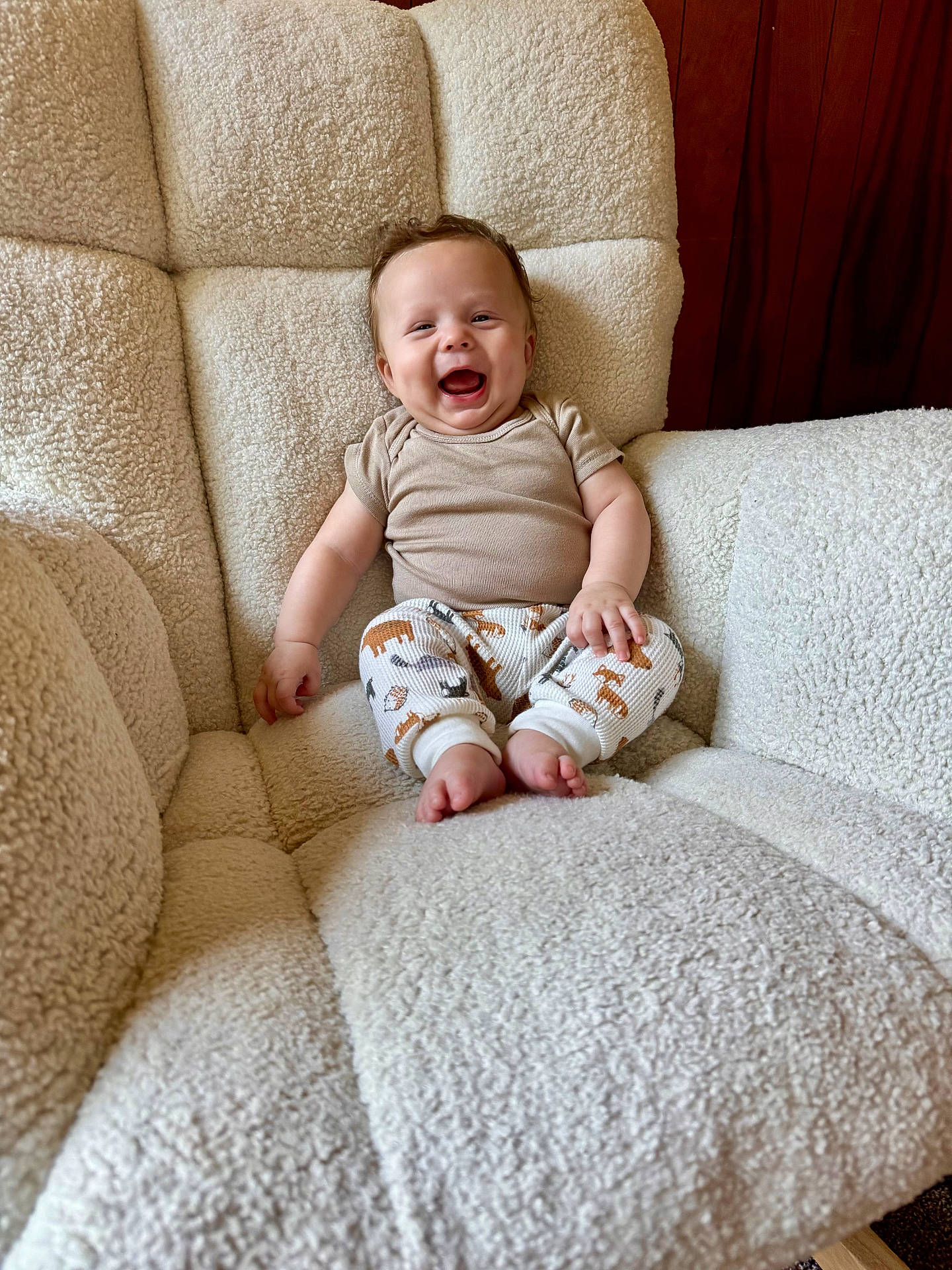 Bodie joined the competition — help win amazing prizes! animal_print, baby, child, comfortable, cozy, cute, furniture, happy, indoor, infant, laughing, onesie, pants, person, plush_chair, portrait, sitting, smiling, texture, wooden_background