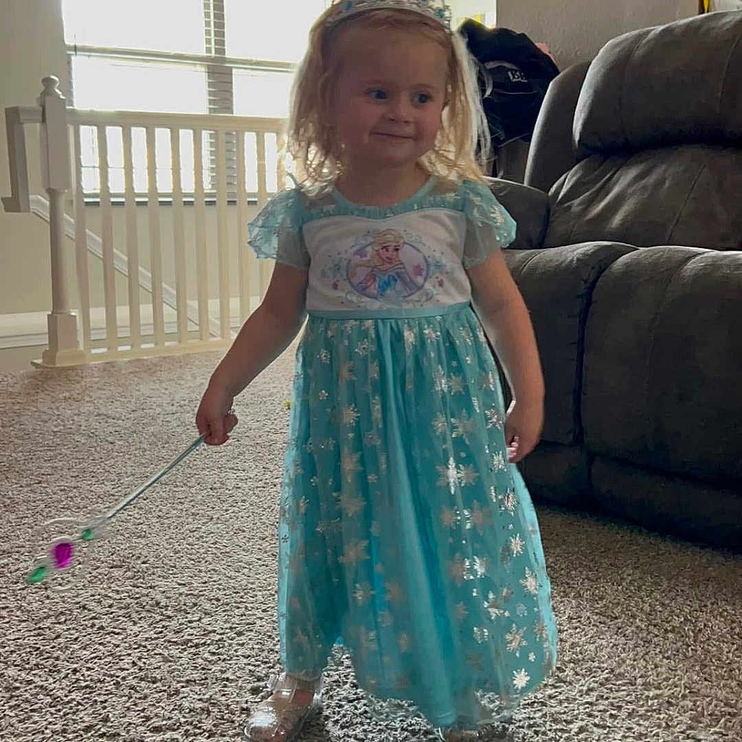 Hadley-Rae is registered to the contest to win money with this photo: carpet, child, costume, curtain, dress, floor, girl, happy, home, indoor, light, living_room, magic_wand, person, princess, smile, sofa, tiara, toy, window