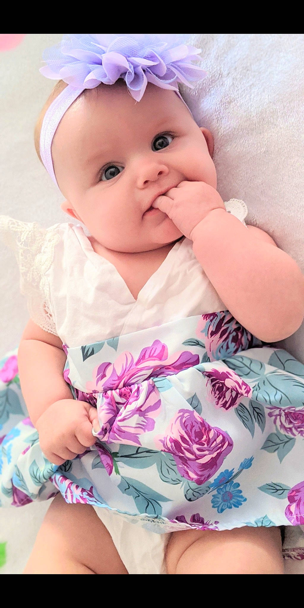 Isabella is registered to the contest to win money with this photo: baby, baby_toddler_clothing, cheek, dress, eye, eyelash, face, finger, gesture, happy, headgear, headwear, iris, lip, person, pink, product, skin, sleeve, textile