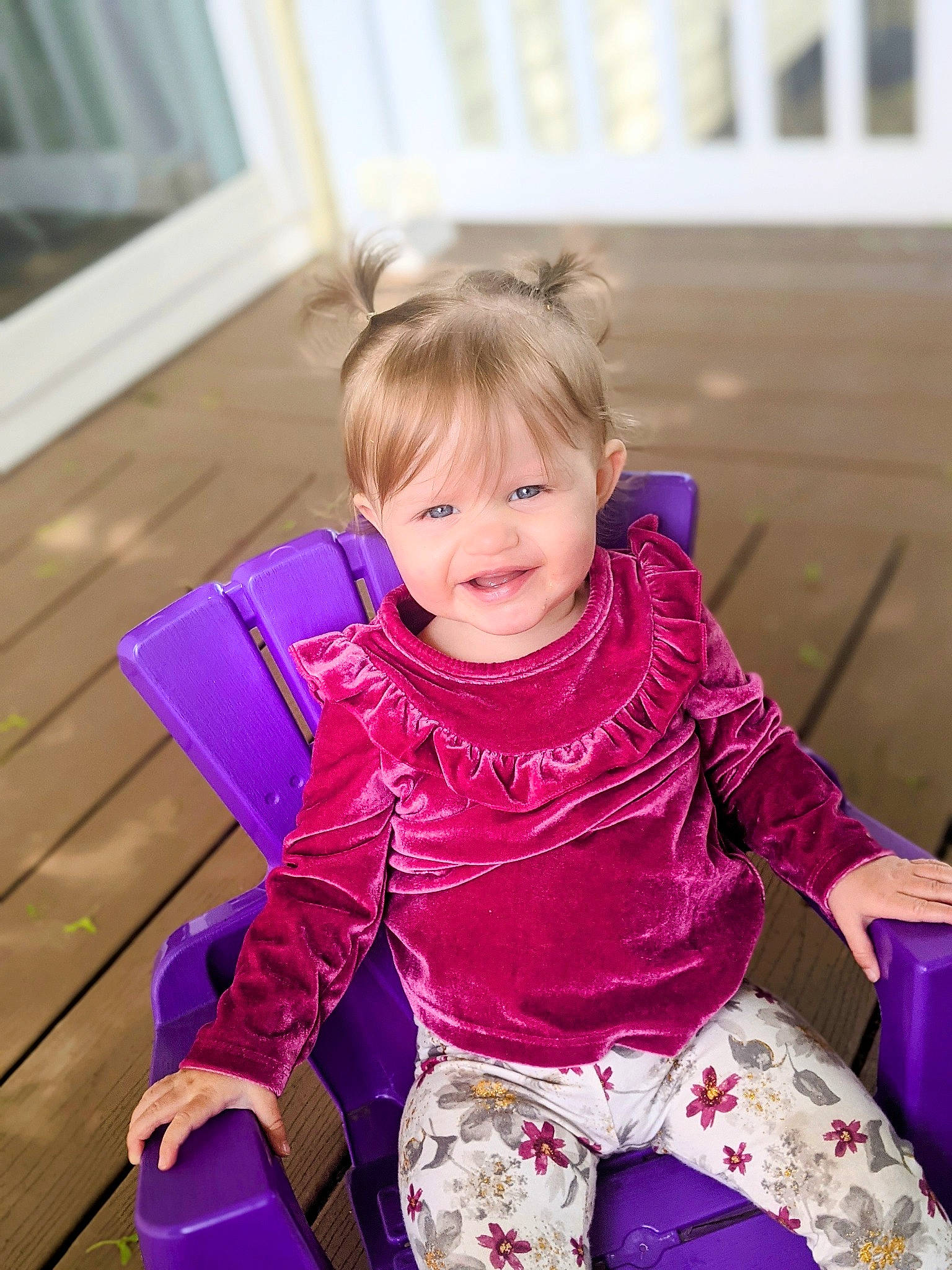 Isabella is registered to the contest to win money with this photo: baby_toddler_clothing, child, electric_blue, facial_expression, fashion_accessory, fun, grass, happy, leisure, magenta, outerwear, person, pink, purple, sitting, sleeve, smile, textile, toddler, violet