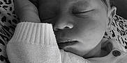 Saint joined the competition — help win amazing prizes! baby, sleeping, infant, cozy, knitted_sweater, patterned_cushion, black_and_white, peaceful, resting, cute, portrait, hand, face, newborn, young_child, closeup, soft_texture, indoor, comfort, relaxation