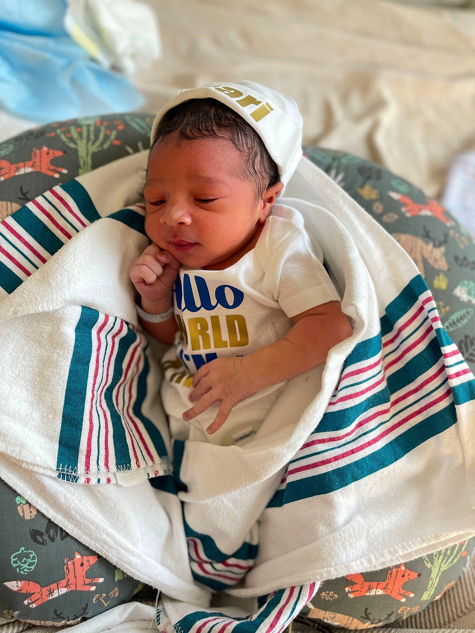 Amari joined the competition — help win amazing prizes! baby, baby_products, baby_toddler_clothing, baseball_cap, cap, carmine, child, comfort, event, fun, happy, hat, human_leg, linens, pattern, person, sitting, sleeve, t_shirt, textile