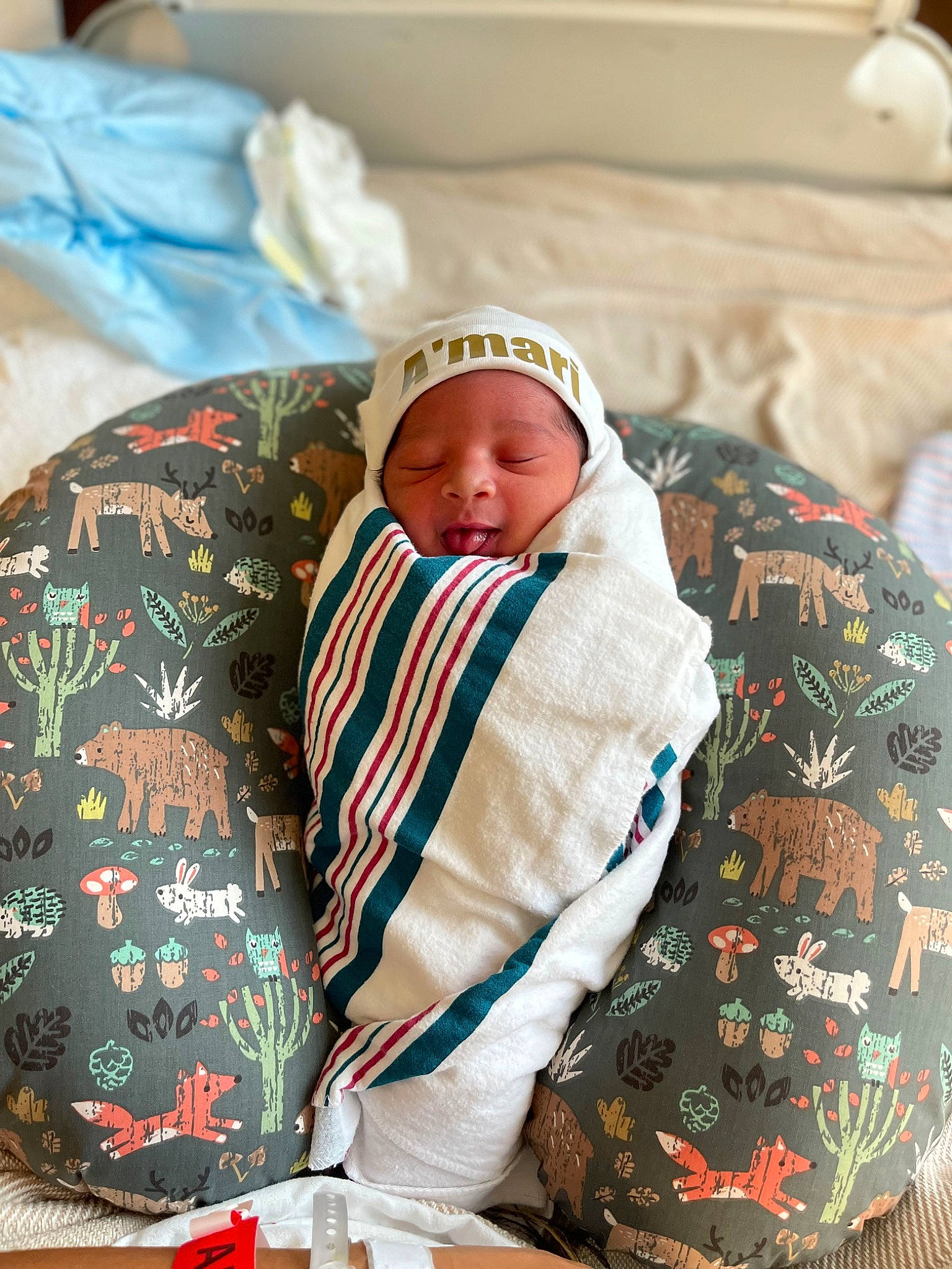 Amari is registered to the contest to win money with this photo: baby, baby_sleeping, bedding, bedtime, carmine, child, comfort, event, face, hat, headwear, linens, nap, pattern, person, room, service, sitting, sleep, tableware