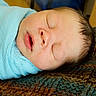 Stetson is registered to the contest to win money with this photo: newborn, baby, sleeping, blanket, blue, wrapped, face, infant, cozy, knitted, texture, soft, peaceful, indoors, closeup, portrait, child, resting, cute, head