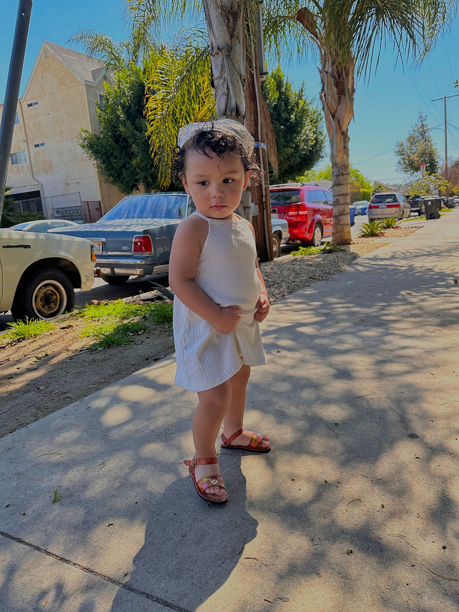 Zaniyah joined the competition — help win amazing prizes! asphalt, car, city, dress, family_car, fun, happy, human_leg, leisure, person, plant, recreation, road, sandal, sidewalk, sky, tire, toddler, tree, vehicle_door
