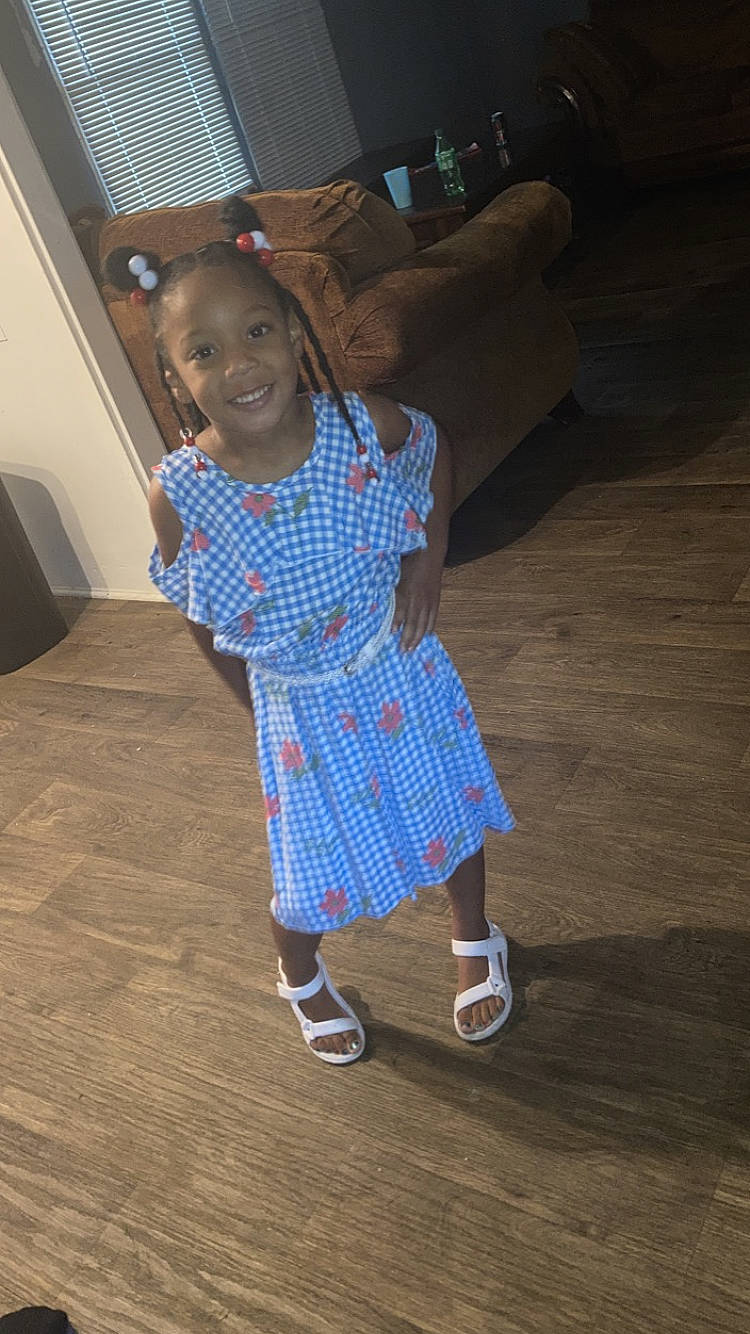 Valleigh is registered to the contest to win money with this photo: baby_toddler_clothing, child, dress, electric_blue, face, floor, flooring, fun, happy, head, human_body, human_leg, joy, one_piece_garment, pattern, person, sandal, sleeve, smile, standing