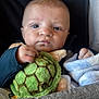 Archie is registered to the contest to win money with this photo: baby, infant, plush_toy, turtle, blanket, clothing, face, hand, seat, comfort, soft, cute, child, portrait, indoors, young, expression, cozy, warm, resting