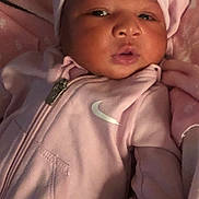 Kaylani joined the competition — help win amazing prizes! baby, infant, pink_clothing, hat, bow, blanket, face, portrait, child, soft_texture, sleepwear, cute, newborn, closeup, apparel, young_child, resting, indoor, person, cozy