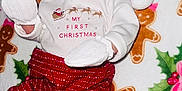 Kaylani joined the competition — help win amazing prizes! baby, infant, christmas, holiday, festive, santa_hat, mittens, red_pants, blanket, gingerbread_men, holly, smiling, cute, cozy, lying_down, celebration, child, person, winter, indoors