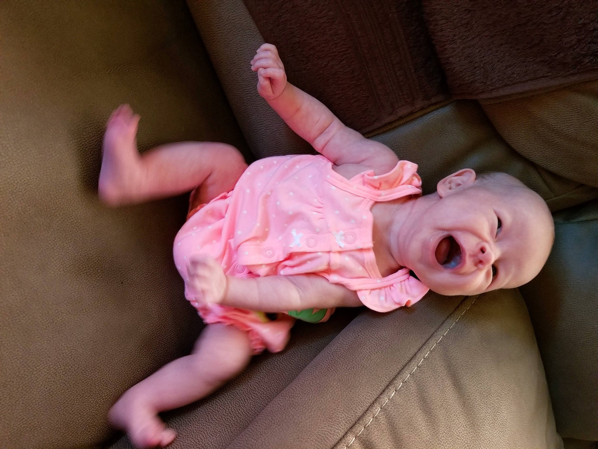 Lilian is registered to the contest to win money with this photo: arm, baby, cheek, child, finger, gesture, hand, leg, mouth, person, pink, skin, smile, toddler