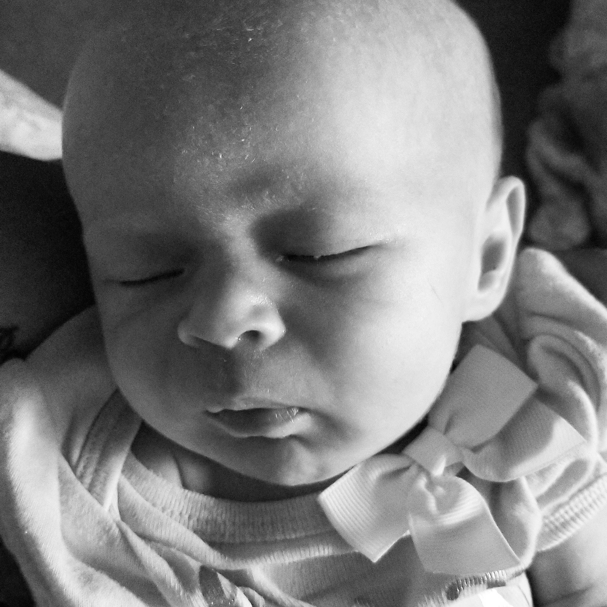 Lilian is registered to the contest to win money with this photo: baby, black_and_white, cheek, child, chin, close_up, eye, face, facial_expression, forehead, head, lip, monochrome, monochrome_photography, mouth, nose, person, photograph, skin, smile