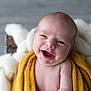 baby, baby_face, blanket, child, cozy, cute, expression, face, happy, indoor, infant, knit_blanket, newborn, portrait, sitting, skin, smile, soft, wrapped, yellow_blanket