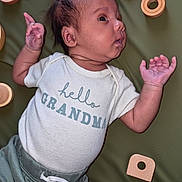 Ka'Mari joined the competition — help win amazing prizes! baby, infant, child, onesie, clothing, wooden_toys, green_mat, curious, portrait, hand, face, cute, laying_down, expression, indoor, newborn, small_hands, soft_lighting, baby_girl, baby_boy