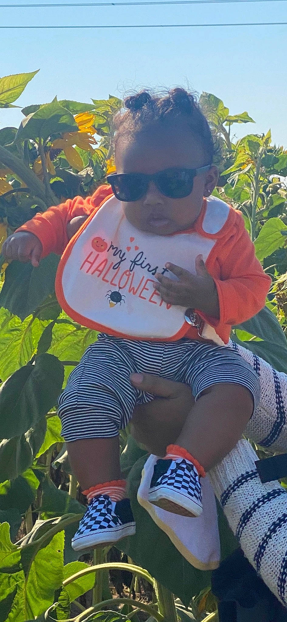 Amani is registered to the contest to win money with this photo: adaptation, beauty, cool, eyewear, fun, glasses, goggles, grass, green, hairstyle, happy, knee, leisure, person, plant, shorts, sock, sunglasses, thigh, toddler