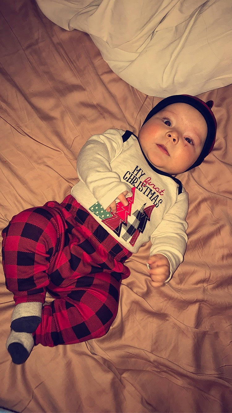 Elijah is registered to the contest to win money with this photo: baby, baby_sleeping, baby_toddler_clothing, child, comfort, hand, happy, headwear, human, human_leg, linens, pattern, person, plaid, room, sleeve, tartan, textile, thigh, toddler
