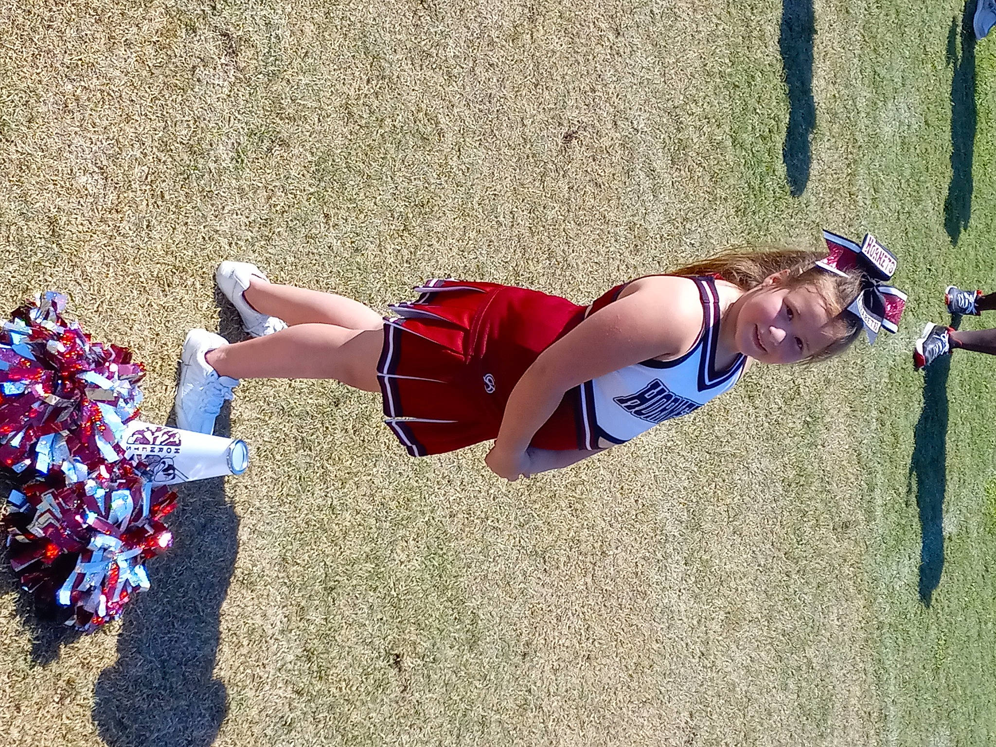 Elizabeth is registered to the contest to win money with this photo: athlete, athletics, competition_event, electric_blue, exercise, fun, grass, human_leg, joy, knee, people_in_nature, person, player, playing_sports, recreation, shorts, sleeveless_shirt, sports, sports_uniform, sportswear