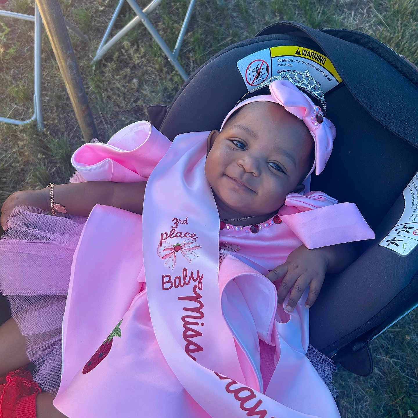 Kaiomi joined the competition — help win amazing prizes! baby, infant, child, smiling, portrait, pink_dress, hair_bow, pageant, sash, third_place, car_seat, outdoor, grass, folding_chair, celebration, infant_clothing, jewelry, happy, sitting, photography