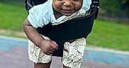 Kaiomi is registered to the contest to win money with this photo: baby, child, swing, playground, outdoor, smiling, sitting, portrait, face, barefoot, chains, rubber_floor, park, grass, trees, daylight, infant, clothing, shorts, happy