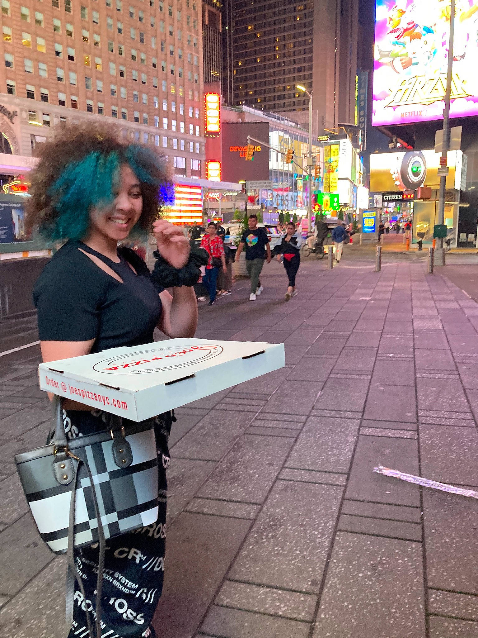 Alana is registered to the contest to win money with this photo: architecture, building, city, event, eyewear, fun, human, human_settlement, infrastructure, joy, metropolis, metropolitan_area, pedestrian, person, public_space, recreation, road, road_surface, sidewalk, smile