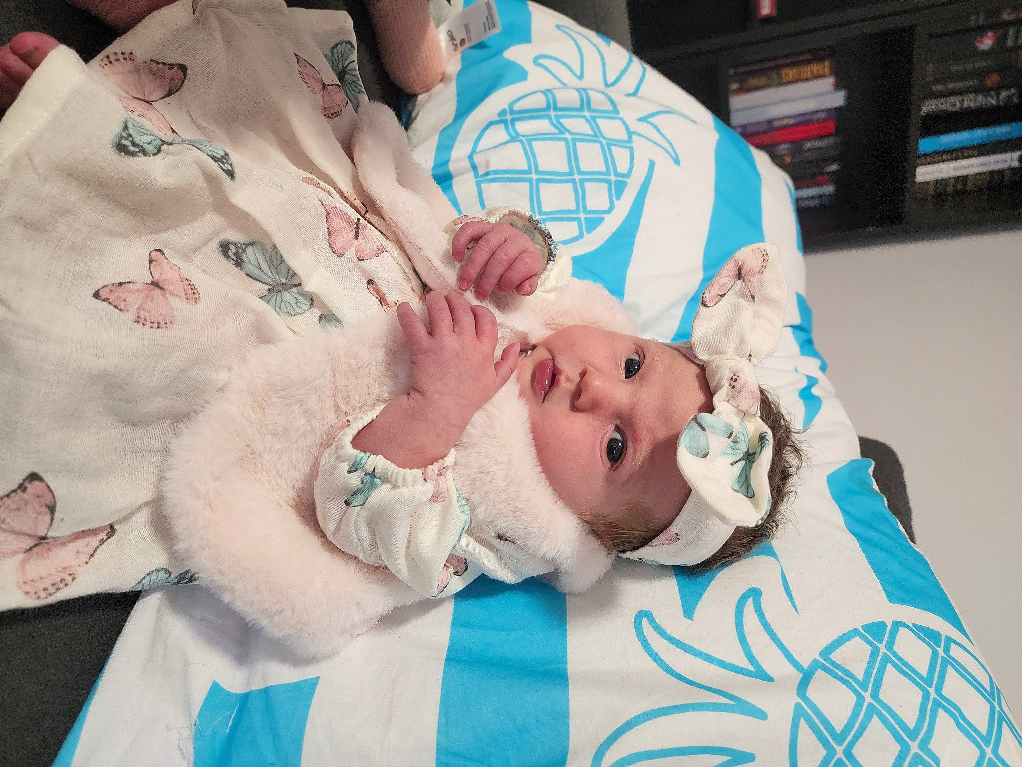 Anastasia is registered to the contest to win money with this photo: baby, baby_toddler_clothing, child, comfort, couch, event, flesh, happy, hat, head, headwear, linens, nail, pattern, person, room, shelf, skin, toddler